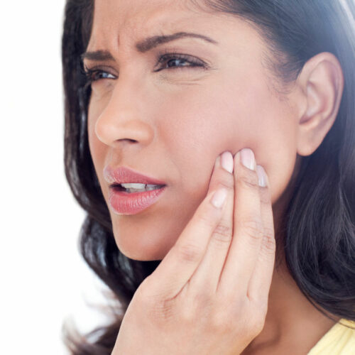 women in pain caused by tmj pain