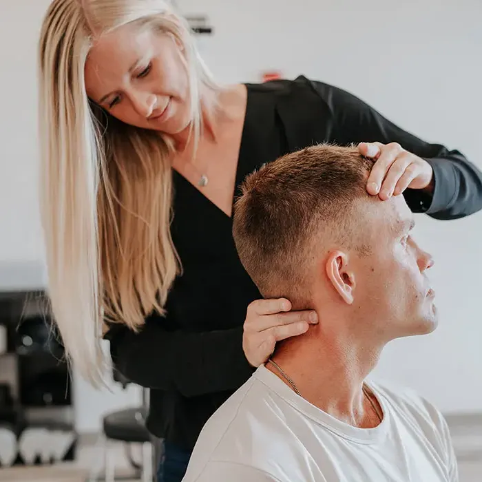 Chiropractor Dr. Emily Payne Performing Neck Exam For Headache Relief.